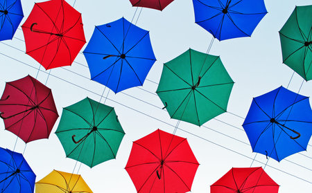Colored umbrellas in the skyの写真素材