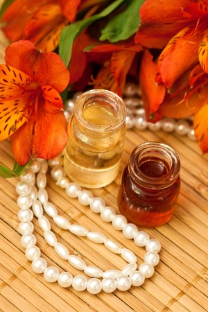 Aromatic oils, alstroemeria flowers and beads of pearlsの写真素材
