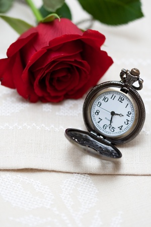 Red Rose and a pocket watch on a napkin embroidered with a crossの写真素材