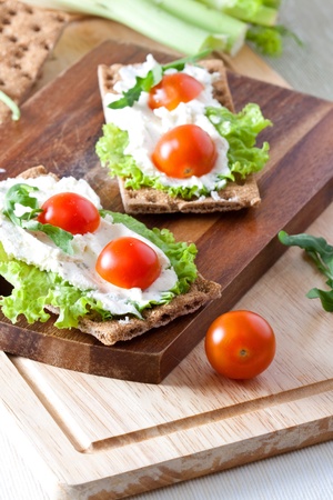 Crispbread with cheese, lettuce and cherry tomatoesの写真素材