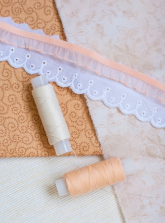 Spools of thread, lace and fabricの写真素材