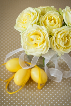 Easter eggs and yellow rosesの写真素材