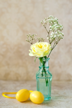 Easter eggs and yellow roseの写真素材