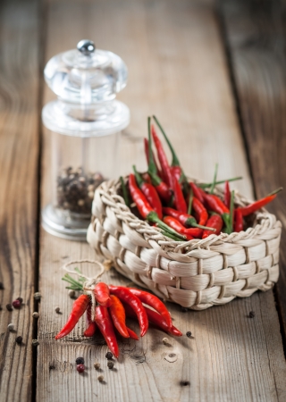 Pods of red pepper in a wicker basketの写真素材