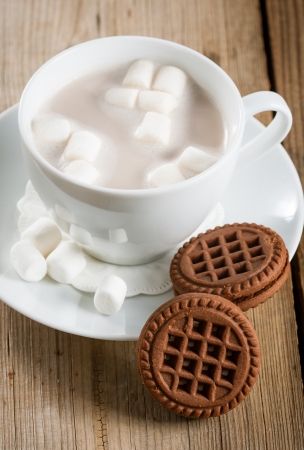 Marshmallows in a cup of Hot Chocolate on a wooden tableの写真素材