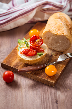 Slice baguette with sun-dried tomatoes in olive oilの写真素材