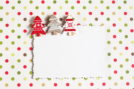 Blank christmas greeting card with small decorative clothespins as firsの写真素材