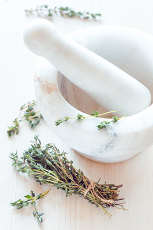 Fresh thyme in a marble mortar and scissorsの写真素材