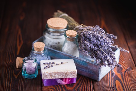 Lavender treatment soap and sea salt on wooden tableの写真素材