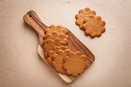Traditional ginger cookies on a wooden cutting board on concrete backgroundの写真素材