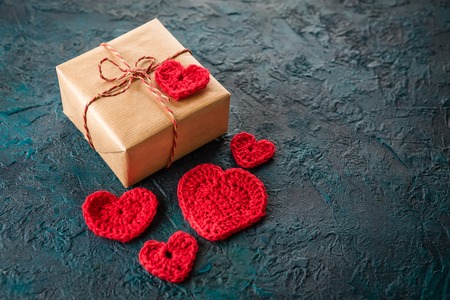 Gift boxes and crochet valentine hearts on dark bacground.の写真素材