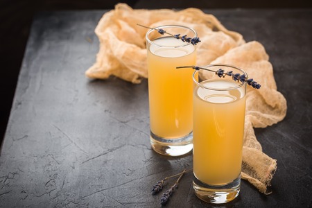 Lavender lemonade with fresh lemon juice on dark backgroundの写真素材