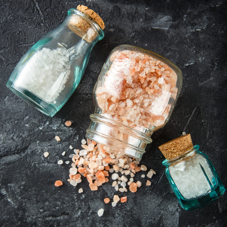 Small glass bottles with aromatic salt. Set for aromatherapy. Top view.の写真素材