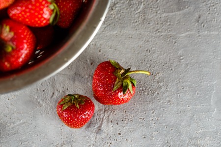 Fresh juicy appetizing strawberries in metal colanderの写真素材