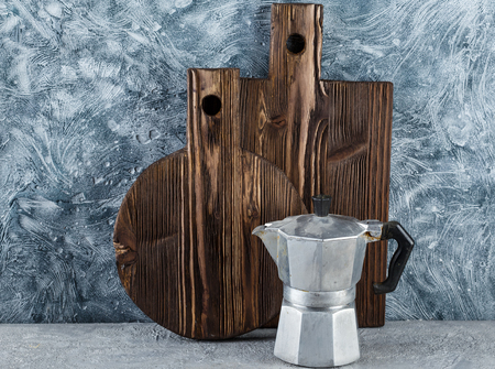 Two textured wooden cutting boards, italian espresso coffee pot - caffettiera and kitchen utensilsの写真素材
