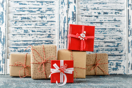 Christmas red and craft paper gift boxes on blue background.