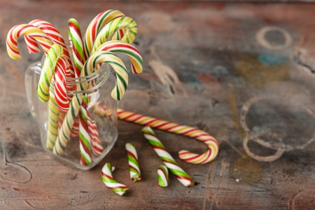 Sweet Candy canes on blue background. Flat lay. Top view.の写真素材