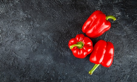 Fresh sweet red pepper on black concrete backgroundの写真素材