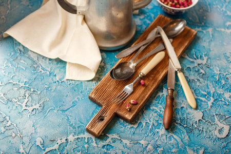 Various kitchen utensils cutlery on blue background