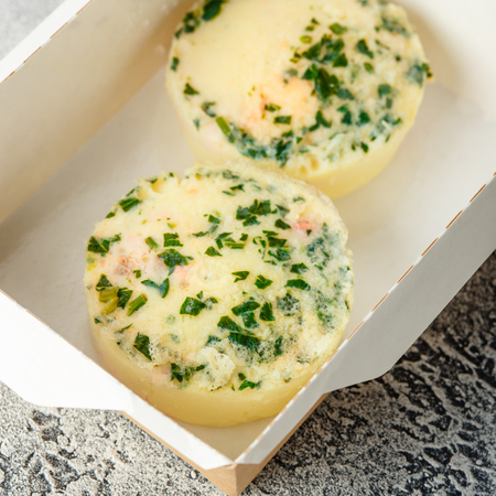 Muffins of eggs with fish and greens in a paper box on a gray background. Healthy food delivery. Take away for diet.の写真素材