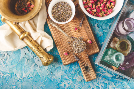 Assortment of dry medicinal herbs roses buds and lavender in bowls. Top viewの写真素材