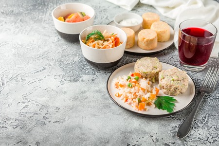 Steam cutlets from chicken and zucchini with boiled vegetablesの写真素材