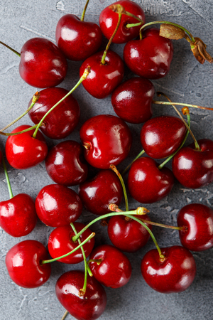 Fresh ripe cherries on grey concrete background. Top viewの写真素材