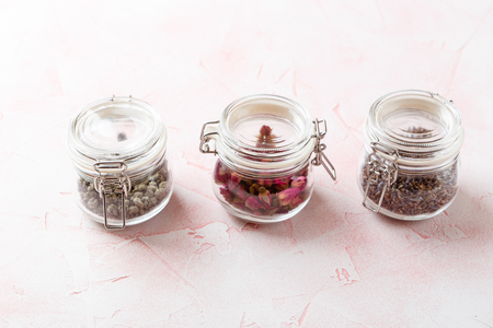 Dried rose flower buds and flowers in glass jars. Herbal tea, cleansing, organic bio productsの写真素材