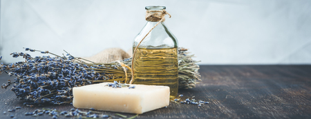 Essential lavender oil, dry lavender flowers, herbal soap and bath salt Long wide bannerの写真素材