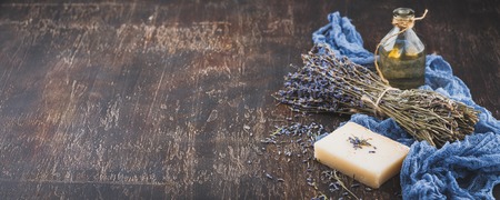 Essential lavender oil, dry lavender flowers, herbal soap and bath salt. Space for text. Long wide bannerの写真素材