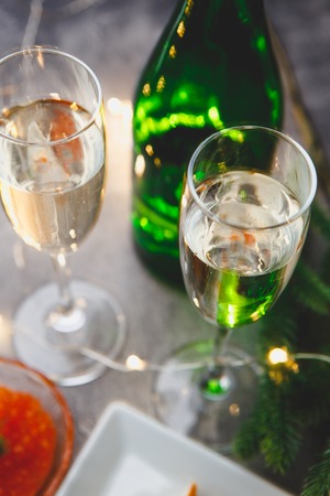 Delicious puff pastry tartlets in the shape of fish with red caviar on a festive table.の写真素材