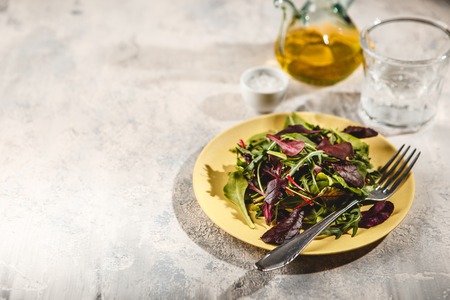 Fresh salad mix of baby spinach, arugula leaves and chard in alad bowl, healthy food, top viewの写真素材