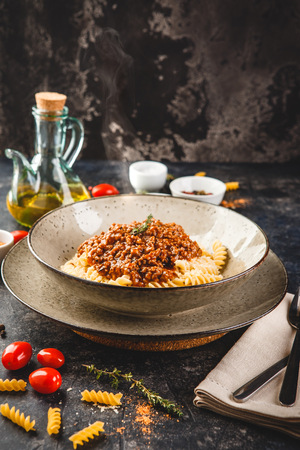 Pasta fusilli with bolognese tomato beef sauce. Traditional italian cuisine. Top view.の写真素材