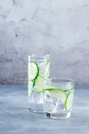 Fresh cool cucumber infused water, cocktail, detox drink, lemonade in a glass. Health care, fitness, healthy nutrition diet concept.の写真素材