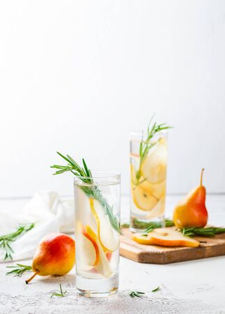 Summer drinks, rosemary pear cocktails with ice in glasses. Refreshing summer homemade Alcoholic or non-alcoholic cocktailsor Detox infused flavored waterの写真素材