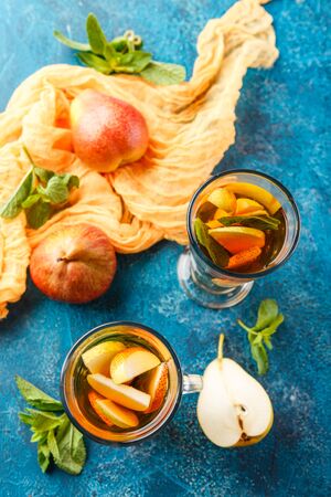 Hot fruit tea with ripe pears and mint, delicious and aromaticの写真素材