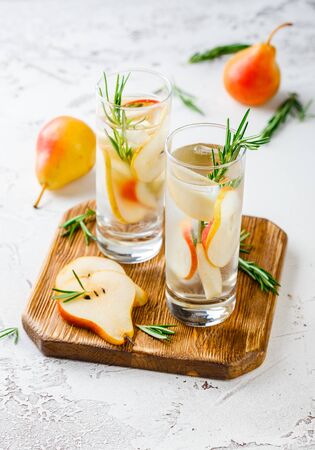 Summer drinks, rosemary pear cocktails with ice in glasses. Refreshing summer homemade Alcoholic or non-alcoholic cocktailsor Detox infused flavored waterの写真素材