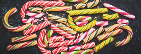 High angle view of a broken candy cane on dark background. Long wide bannerの写真素材