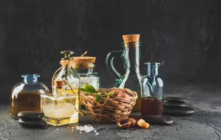 Glass bottles with Natural macadamia oil with macadamia nuts, sea salt and zen stones. Superfood and healthy food conceptの写真素材