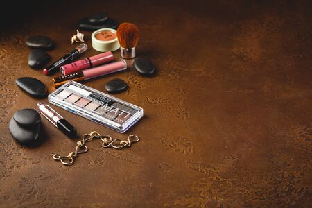 Set of decorative cosmetics - eye shadow, blush, lipstick, eye gloss and make-up brush.のeditorial素材