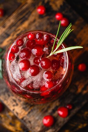 Cranberry cocktail with rosemary and ice in glass, close up. Top viewの写真素材