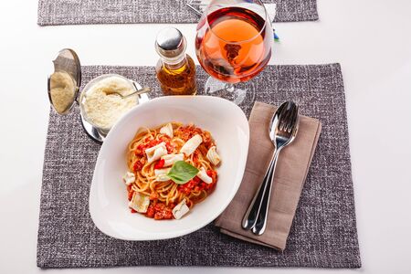 Spaghetti pasta with squid and tomato sauce and parmesan. Restaurant dish. close upの写真素材