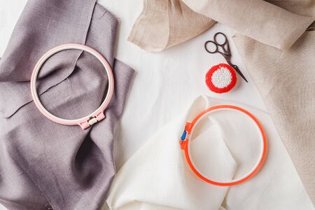 Embroidery set. White linen fabric, embroidery hoop, colorful threads and needls. Copy space.の写真素材