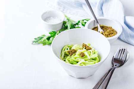 Healthy Zucchini Noddles with pesto on white background. Place for text.の写真素材