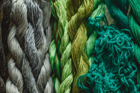 Colorful background from embroidery threads in gray and green colors. Close-up shotの写真素材