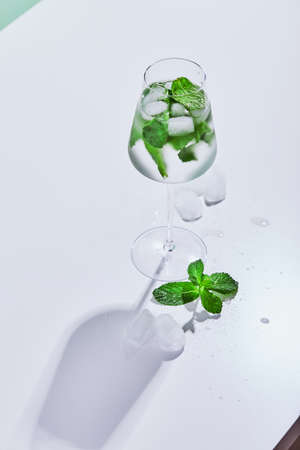 Summer drink, fresh lemonade with mint and ice in glass. Mint infused water, alcoholic or non-alcoholic cocktail, detox drink or lemonadeの写真素材