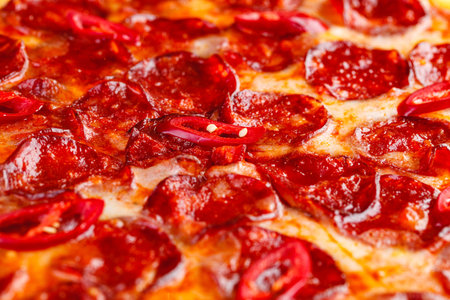 Pepperoni pizza on wooden board on a dark background. Close-up