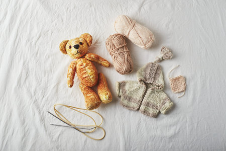 Handmade yellow plush teddy bear, knitted little sweater for a bear, thread and knitting needles for...