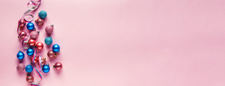 Small pink and blue Christmas balls on pink background