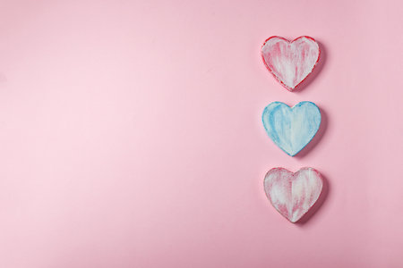 Valentine hearts made of paper mache. Symbol of love and holiday Valentine's Day. Minimalism concept, template for congratulations. Top view, place for text.の写真素材